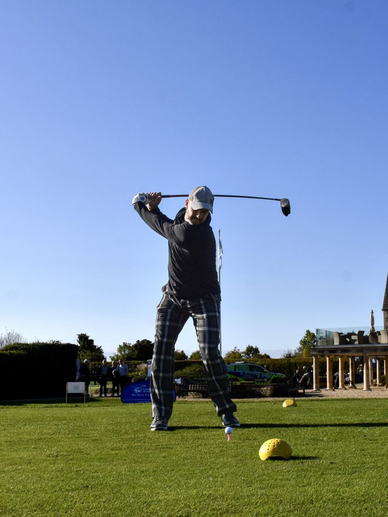 A man swings a golf club 