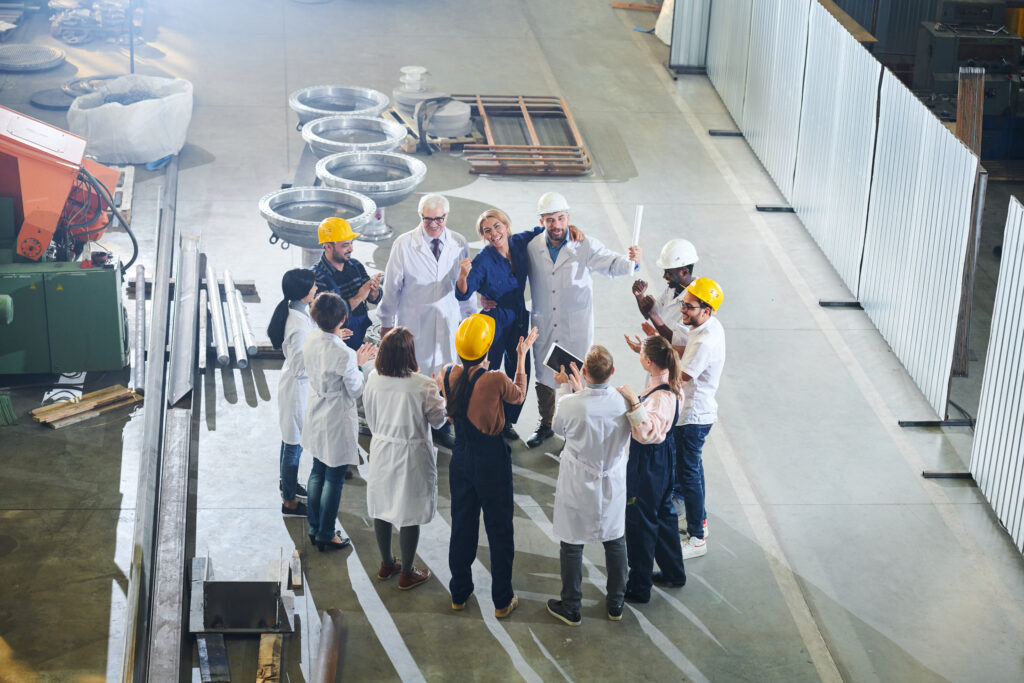 Factory workers applauding management.