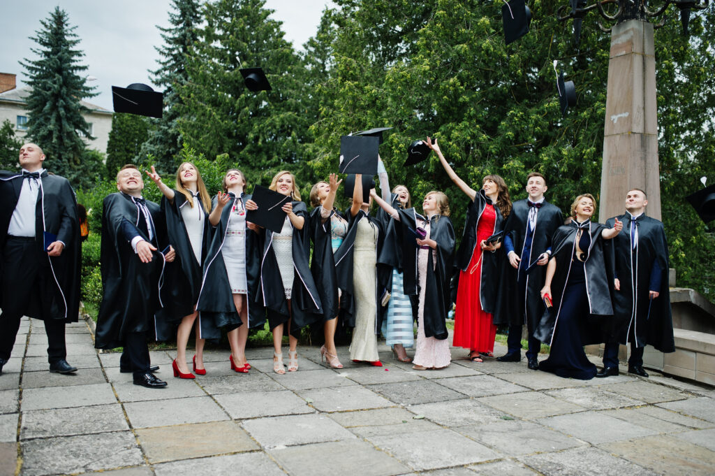 Graduating students throw their caps in the air