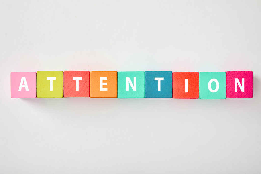Coloured tiles spell out the word 'attention'